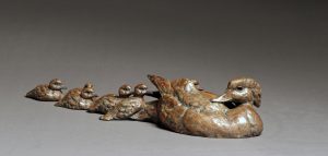 “Ducks in a Row”-Bronze Wood Duck Hen with Babies 3.5” H x 19.5" W x 5.5” D Edition 35